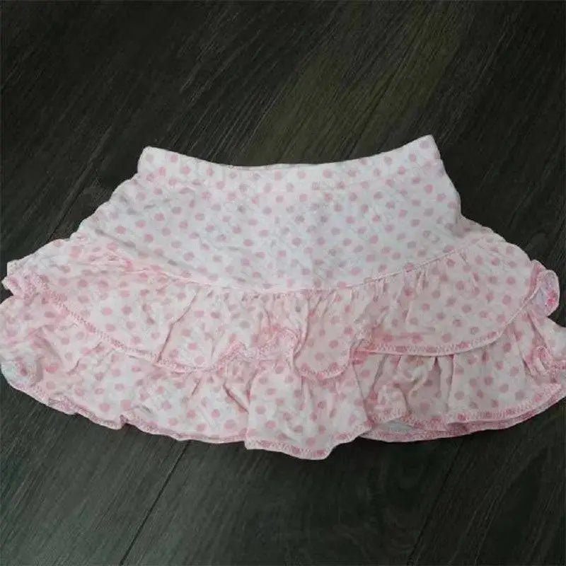 A soft pink and white polka dot ruffled hot girl skirt with lace trim and a flowing design for leopard print sexy looks