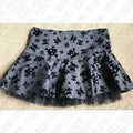 A dark gray pleated hot girl skirt with black skull crossbones pattern and lace trim sheer tulle hem