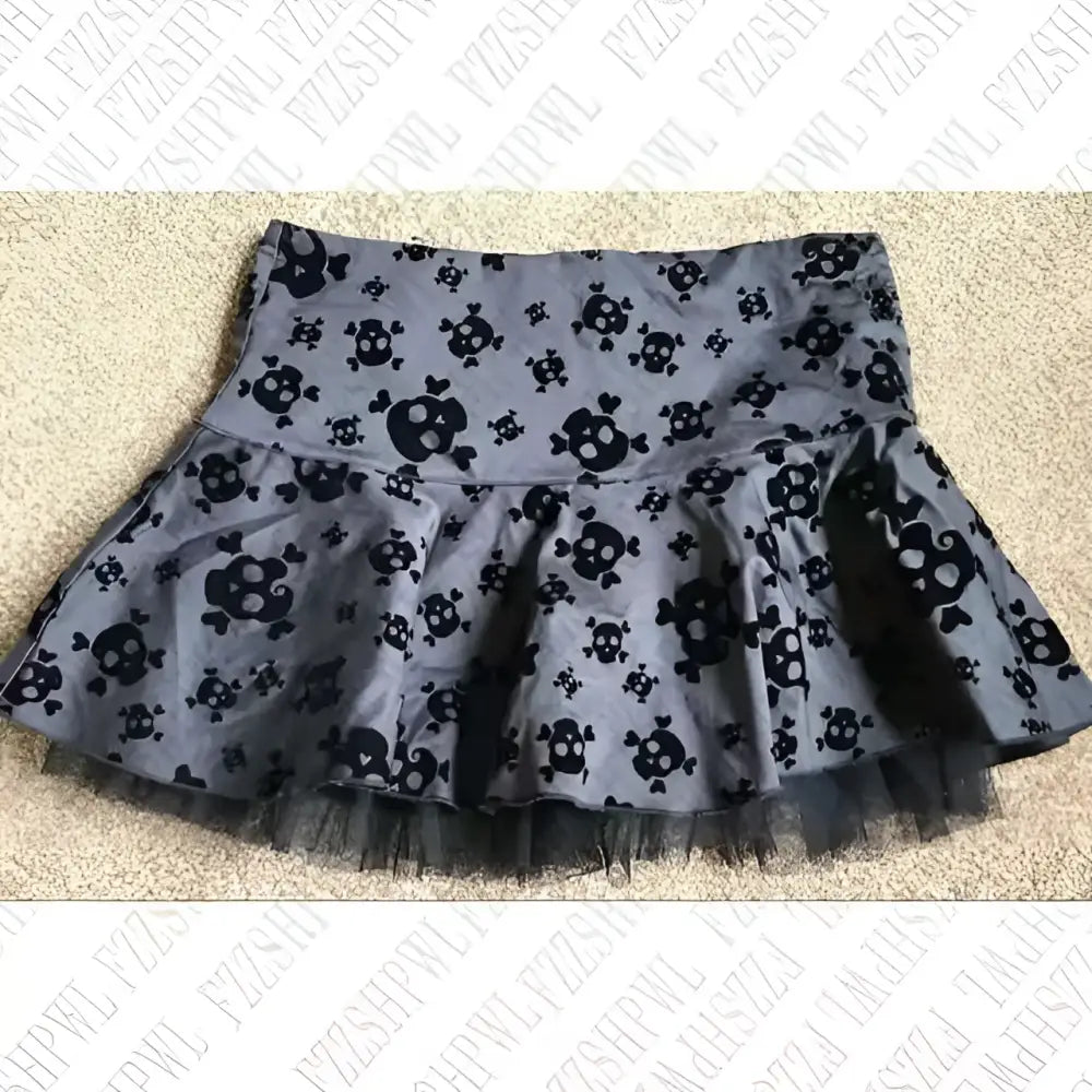 A dark gray pleated hot girl skirt with black skull crossbones pattern and lace trim sheer tulle hem