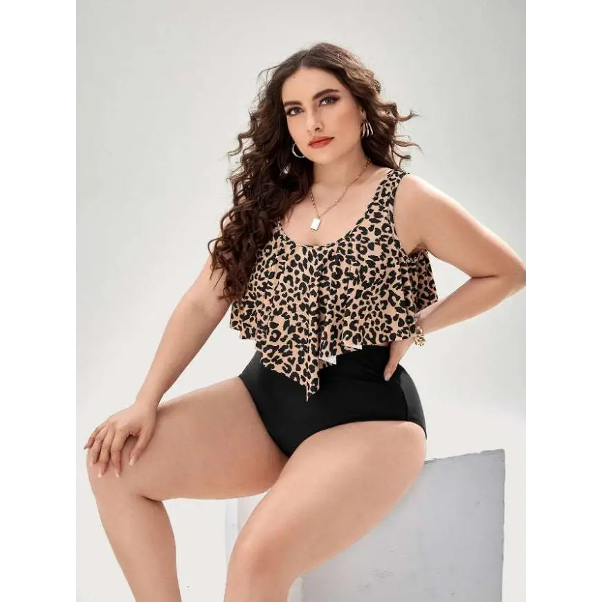 A stylish leopard print swimsuit with ruffled tankini top and high-waisted black bottoms for plus-size women