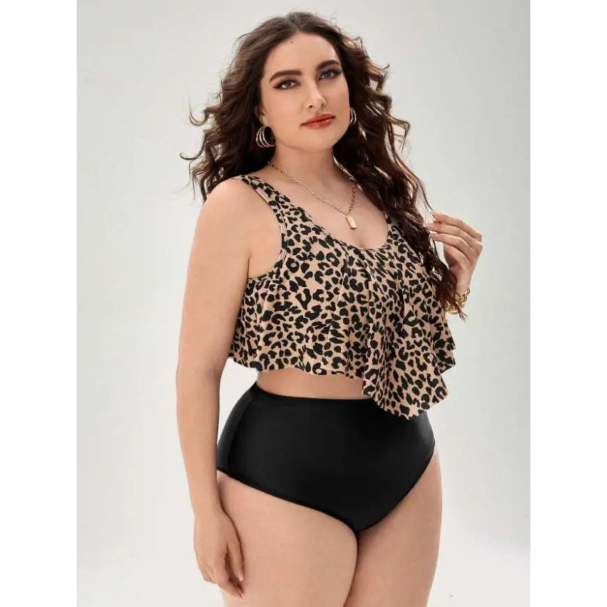 A stylish plus-size leopard print swimsuit featuring a ruffled tankini top with thin straps and high-waisted black bottoms