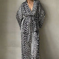 Black and white leopard print two-piece suit fashion set featuring a flowing robe with v-neckline belted waist and wide sleeves
