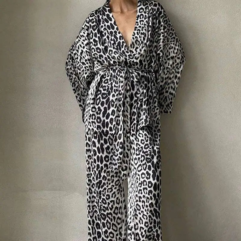 Black and white leopard print two-piece suit fashion set featuring a flowing robe with v-neckline belted waist and wide sleeves