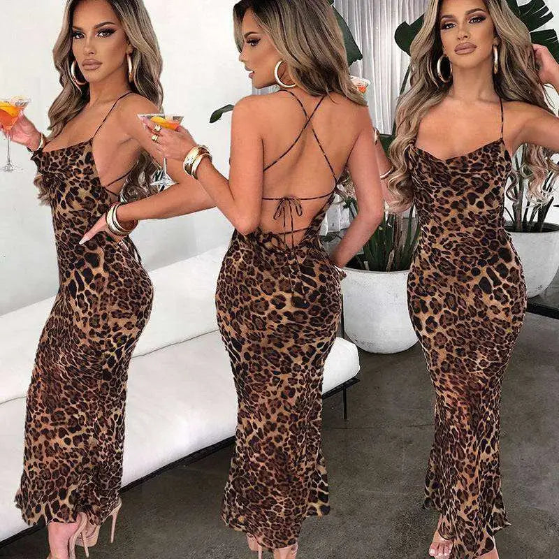 A slim fit long leopard printed lace dress with a plunging neckline and crisscross back detailing