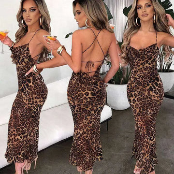 A slim fit long leopard printed lace dress with a plunging neckline and crisscross back detailing