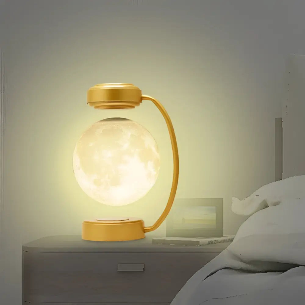 Golden levitating led moon night light with magnetic base featuring a translucent illuminated lunar surface