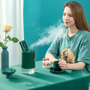 Green cylindrical lifting fan humidifier with clear water reservoir and remote control for portable use