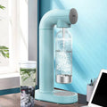 Light blue bubble water machine with clear glass bottle and silver base for making bubble water at home