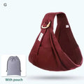 Maroon fabric newborn sling with wooden ring and small front pocket for use as nursing cover