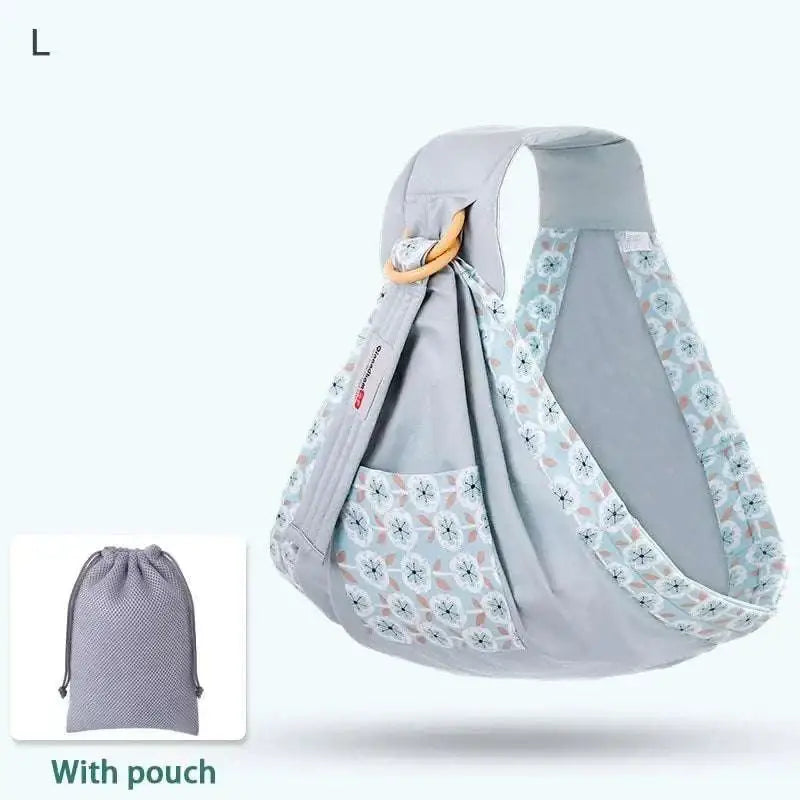 Light blue mesh newborn sling with wooden ring and adjustable straps featuring a subtle floral nursing cover pattern