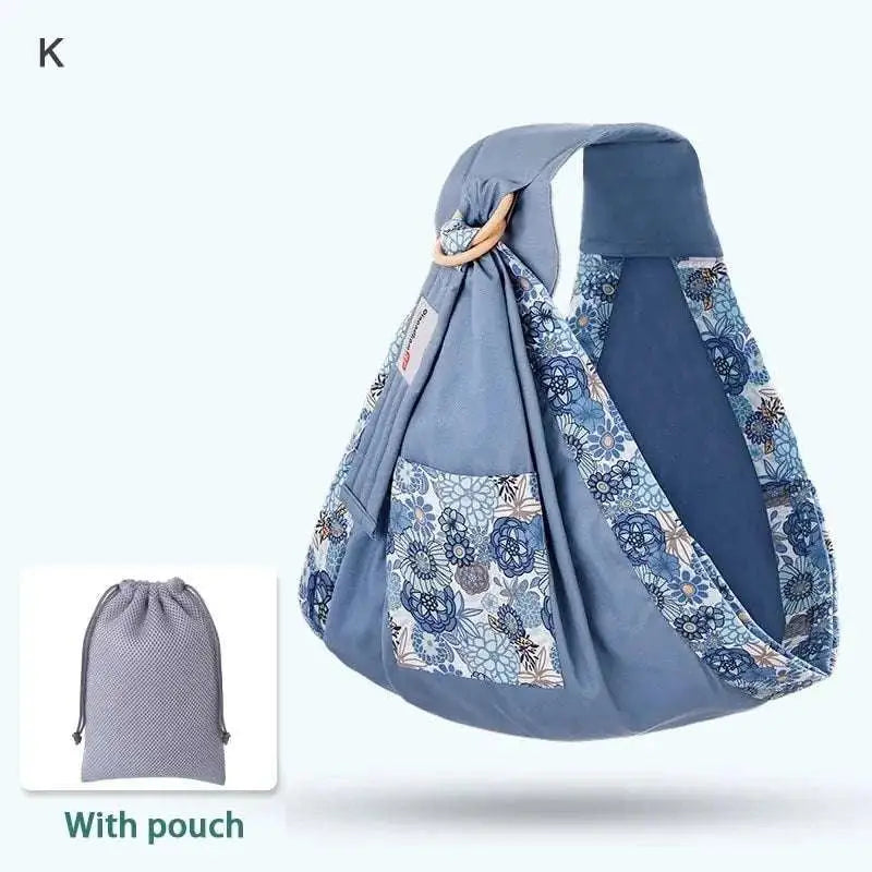 Light blue mesh newborn sling with wooden ring featuring blue floral pattern and matching drawstring pouch for nursing cover
