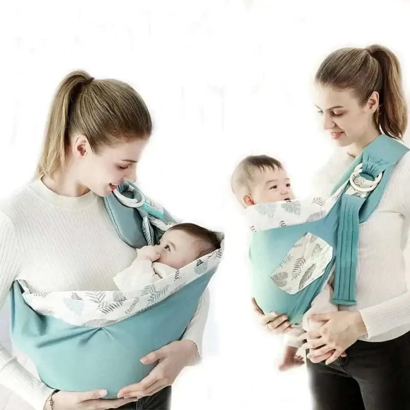 Light blue mesh newborn sling with wooden ring and adjustable straps in teal and white leaf pattern for nursing cover use