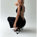 Black high-heeled sandals with gold ysl logo and black tie straps paired with light blue satin slim backless dress summer gown