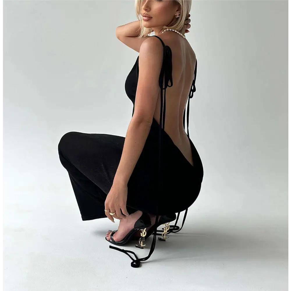 Black high-heeled sandals with gold ysl logo and black tie straps paired with light blue satin slim backless dress summer gown