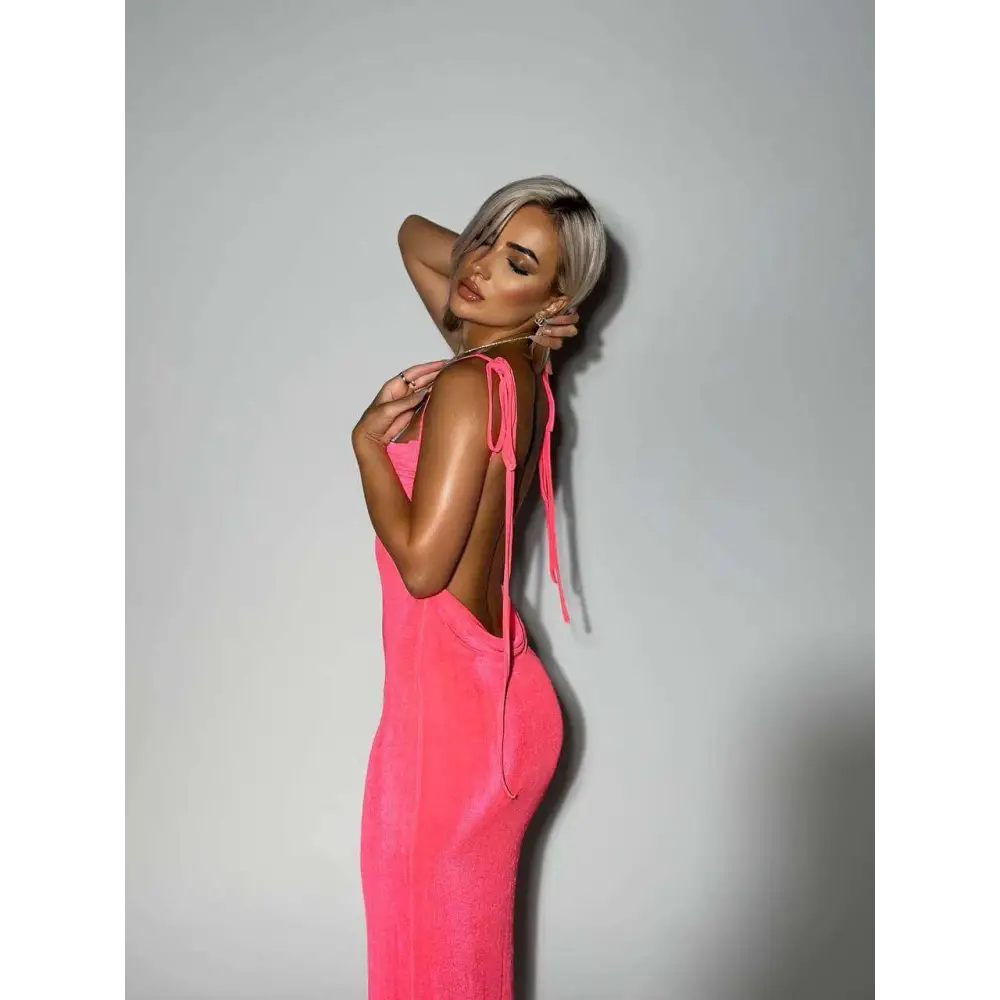 A vibrant pink satin slim backless dress with back tie detail contrasting a light blue satin dress summer gown