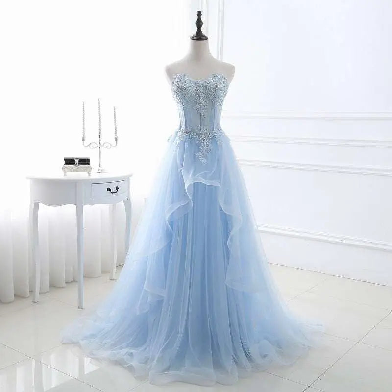 Light blue slim fit bridesmaid gown with silver beading and a flowing tulle skirt for elegant occasions