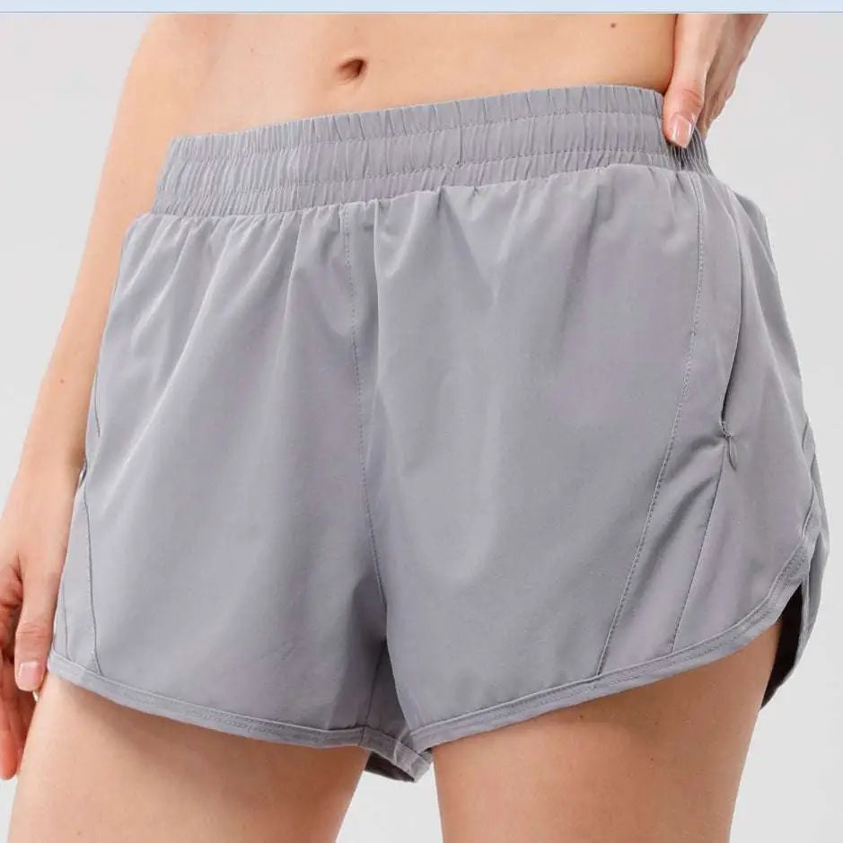 Light blue summer sports shorts with elastic waistband and breathable fabric featuring zipper pockets for secure storage