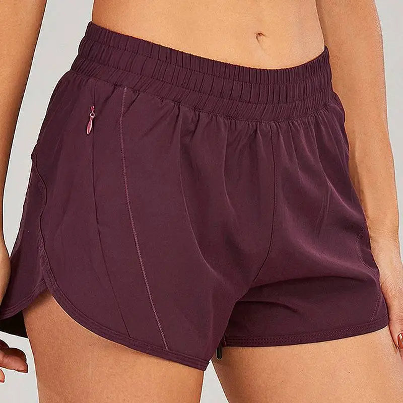 Purple summer sports shorts with elastic waistband breathable fabric and subtle pink zipper pockets accents