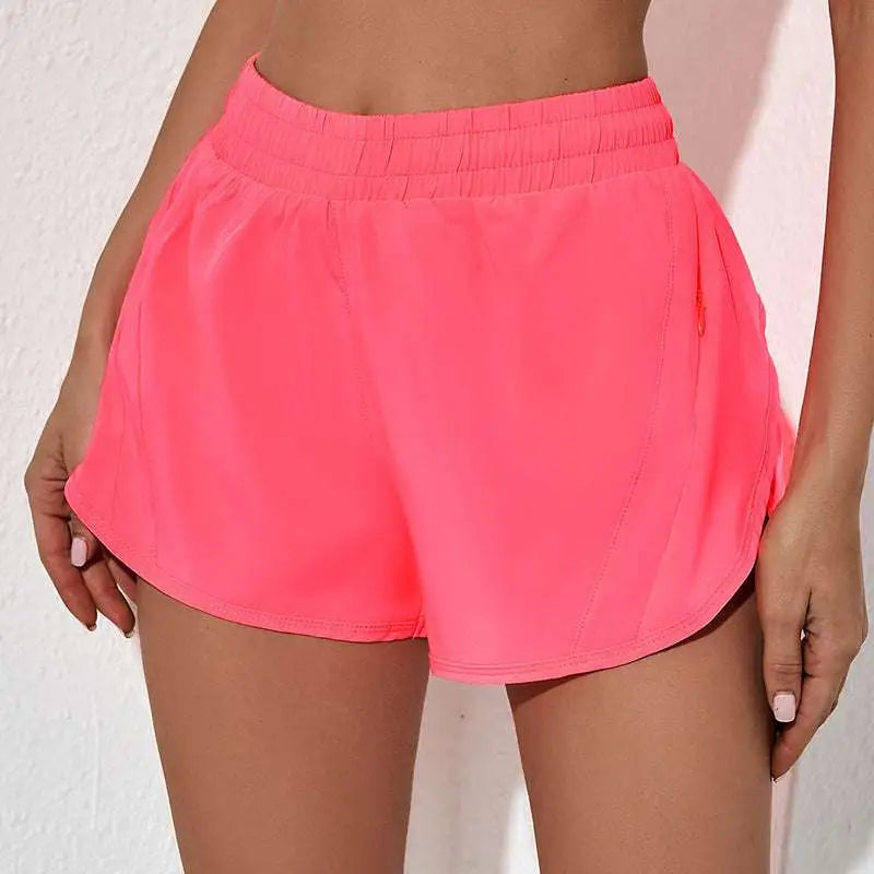 Bright pink summer sports shorts with elastic waistband and breathable zipper pockets for active use