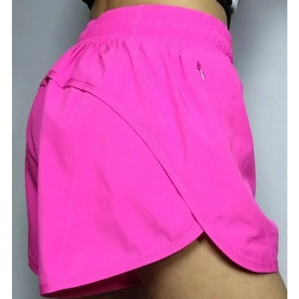 Bright pink summer sports shorts with breathable fabric elastic waistband and small zipper pockets on the side
