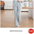 Light blue tailored business suit pants with gold buttons featuring a sleek design and subtle side slits
