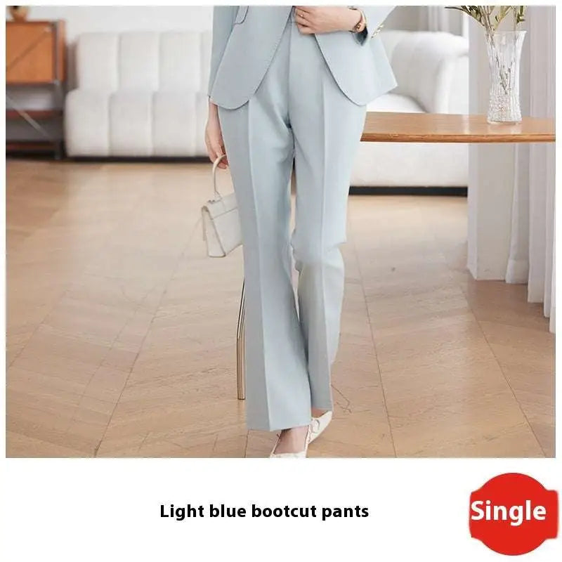 Light blue tailored business suit pants with gold buttons featuring a sleek design and subtle side slits