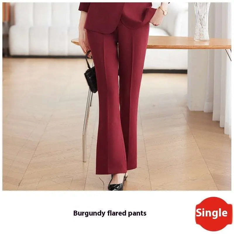 Burgundy flared pants with smooth tailored fabric and clean seams complementing light blue tailored business suit with gold buttons