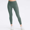 A pair of olive green seamless high waisted leggings made from stretchy fabric designed for butt lifting workout