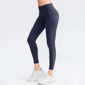 Dark navy seamless high waisted leggings with subtle side seams designed for butt lifting workout and lifting workout leggings