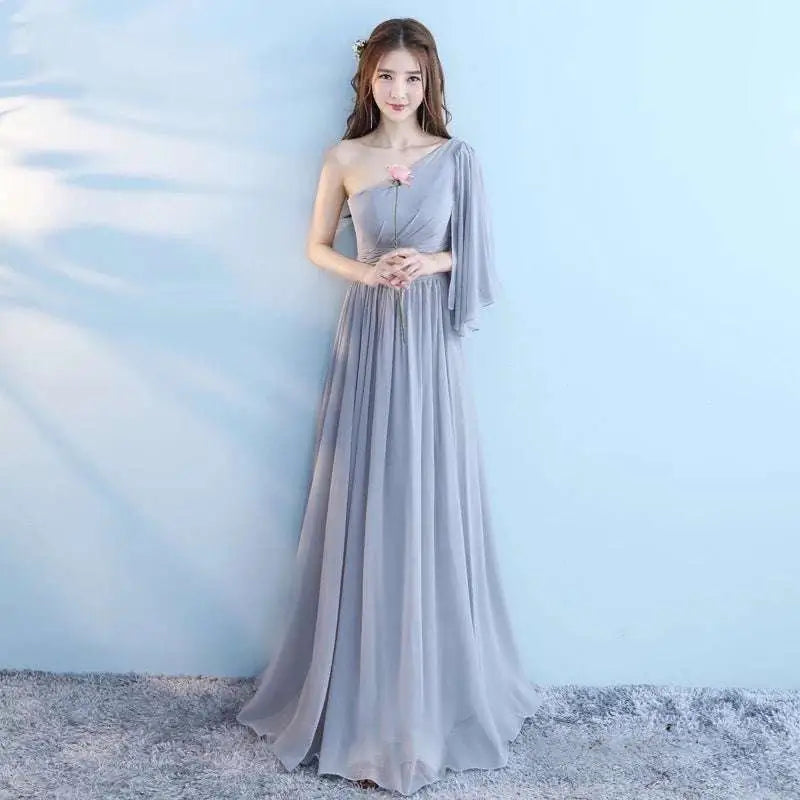 Light gray chiffon wedding bridesmaid dress with one-shoulder design and pink floral accent for bridesmaid sisters