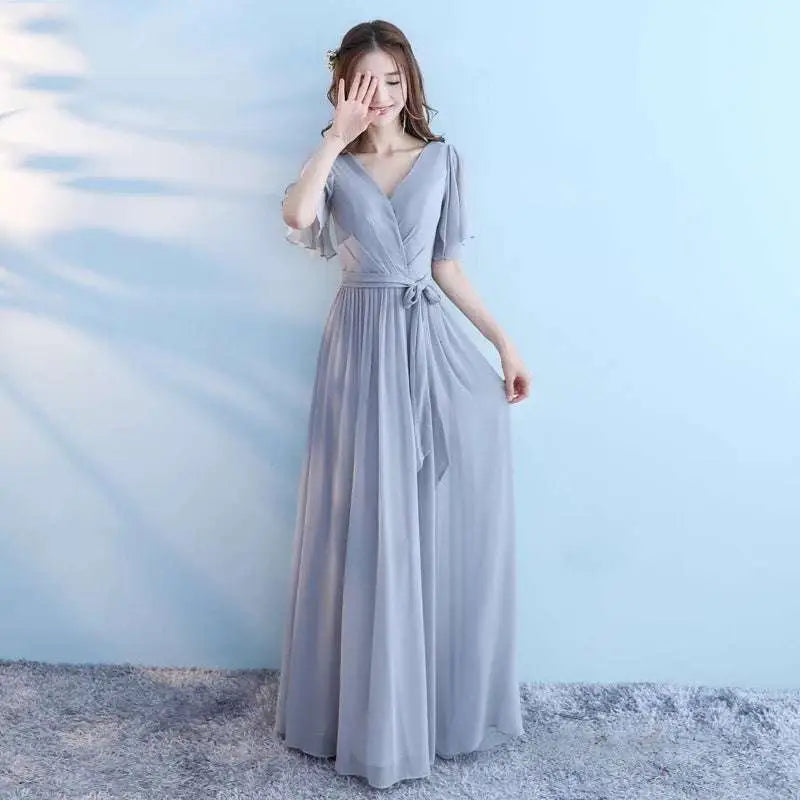 Flowing light gray chiffon wedding bridesmaid dress with v-neckline flutter sleeves and self-tie waistband for bridesmaid sisters
