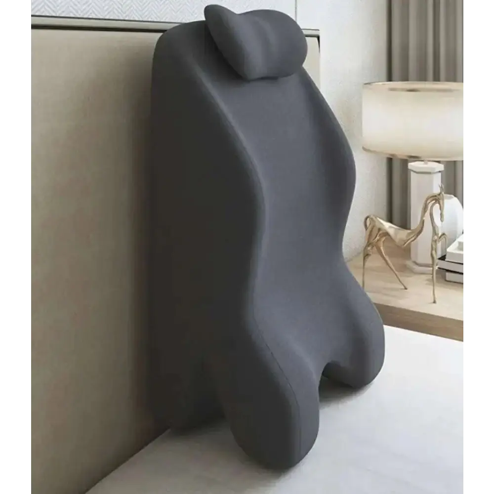 Dark gray ergonomic lumbar support pillow with contoured shape and integrated headrest for light green reclining chair and stomach sleeper pillow