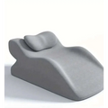 Light green reclining chair with stomach sleeper pillow featuring a gray ergonomic recliner with integrated headrest