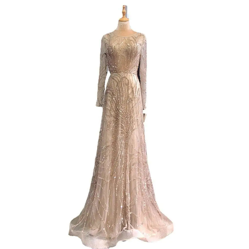 A luxury minority champagne beaded evening gown with long sleeves and intricate detailing flowing to the floor