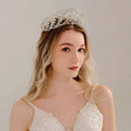 A delicate silver crystal wedding tiara with intricate star-shaped embellishments in luxury socialite style hair design