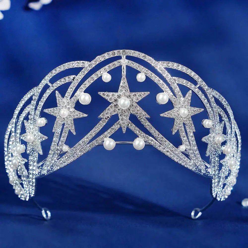 A sparkling silver crystal wedding tiara with rhinestones and pearls in a luxury socialite style hair design