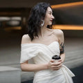 White off-the-shoulder light wedding gown with draped fabric and ruched bodice short mini dress for women