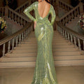 Shimmering lime green slim sequined mermaid gown with long sleeves and deep back cutout shown from the back side