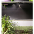 A sleek metallic copper outdoor misting adjustable lock type spray nozzle emitting fine atomizing micro spray droplets
