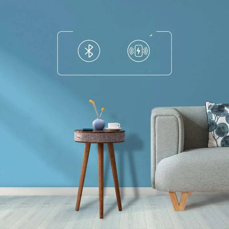 Wooden tripod side table with gray textured fabric top and integrated wireless charging for smart voice devices