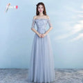 Long bridesmaid blue lace and tulle dress featuring intricate lace detailing and a flowing skirt for wedding occasions