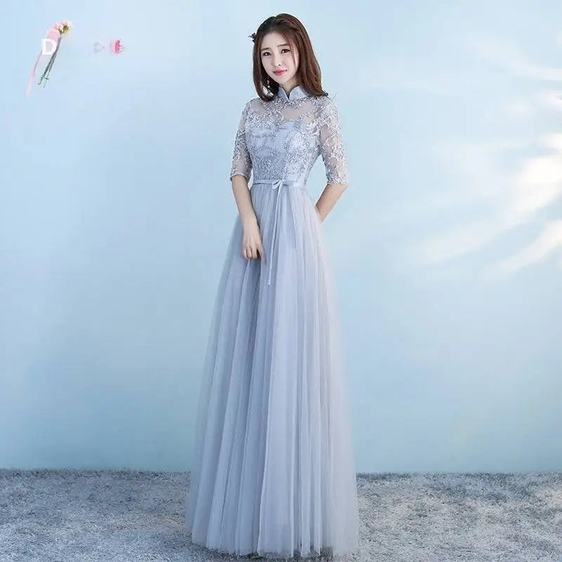 Long bridesmaid blue lace dress with high collar, three-quarter sleeves, embroidered bodice, and flowing tulle skirt