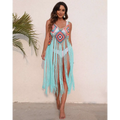 A vibrant long fringed panel beach blouse crochet dress with colorful geometric patterns and turquoise fringe