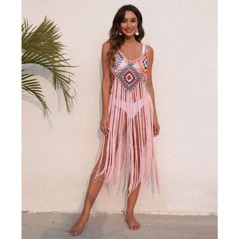 A vibrant pink long fringed panel beach blouse crochet dress with a colorful geometric pattern on the bodice