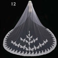 Long lace wedding veil in white featuring intricate floral embroidery on delicate lace displayed on mannequin