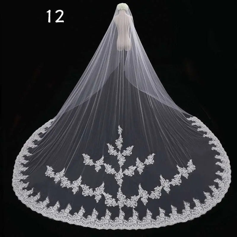 Long lace wedding veil in white featuring intricate floral embroidery on delicate lace displayed on mannequin
