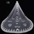 Long lace wedding veil in white featuring intricate floral embroidery and scalloped lace edges for bridal use