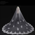 Long lace wedding veil with delicate white lace and intricate floral embroidery displayed on a mannequin