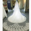 A flowing white long lace wedding veil with intricate floral embroidery along the hemline for bridal use