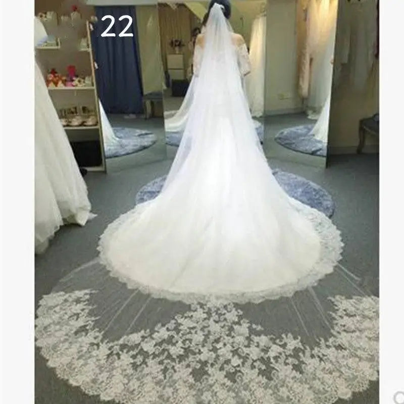 A flowing white long lace wedding veil with intricate floral embroidery along the hemline for bridal use